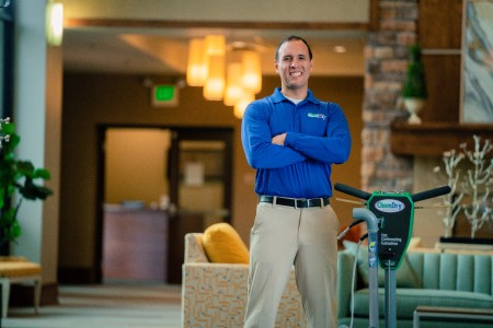 Technician stands in lobby folding his arms