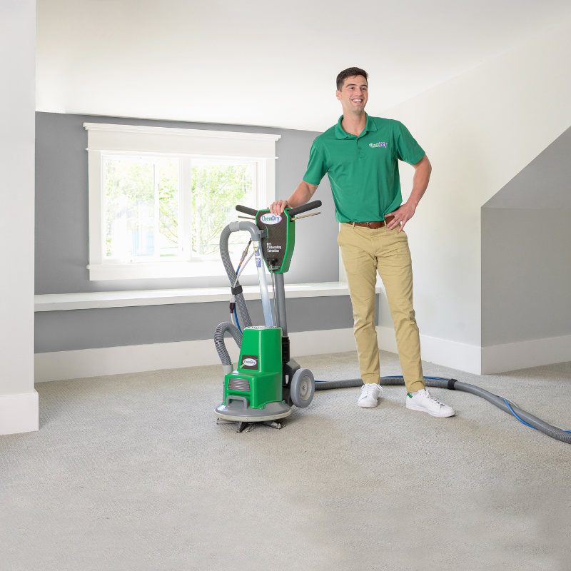 Green Leaf Chem-Dry technician with a carpet cleaning powerhead Green Leaf Chem-Dry technician with a carpet cleaning powerhead