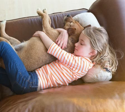 girl on leather couch with dog